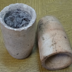 Cupels for assays and refining noble metals. (credit: LukaszKatlewa, license: CC BY).  Cupels, i.e. porous crucibles made e.g. of bone ash or magnesite, used in the process of cupellation for the acquisition and purification of noble metals, as well as the determination of the composition of these ores. Dissolved at high temperature in molten lead, the ore is reduced by charcoal, which burns in oxygen penetrating through the porous walls of cupel. At the end of the process, the cooled cupel is broken, and at its bottom is a layer of precious metal with a density greater than lead.