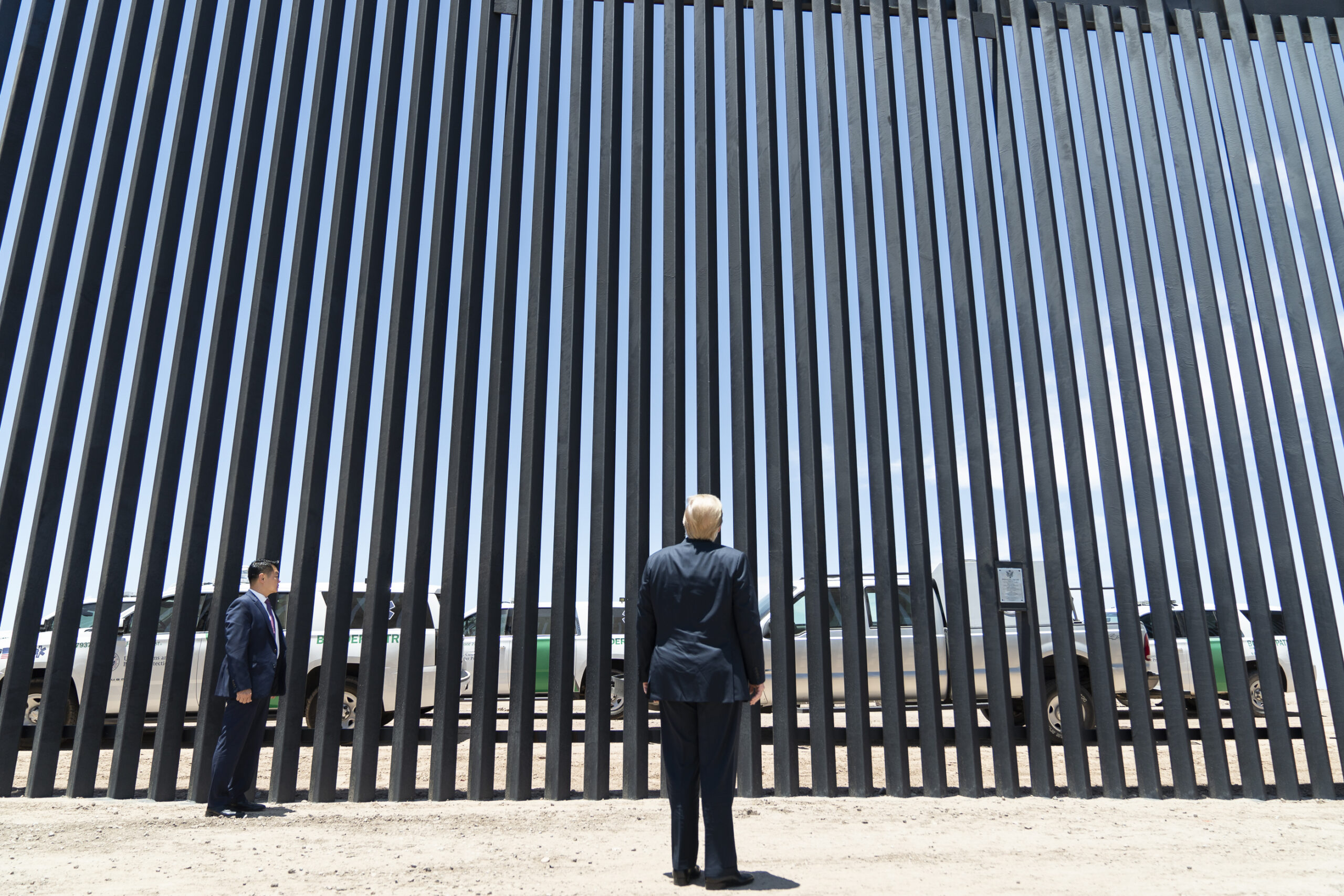 Donald Trump stands in front of a section of border wall near Yuma, Arizona, June 2020  (credit: The White House, license: PD)