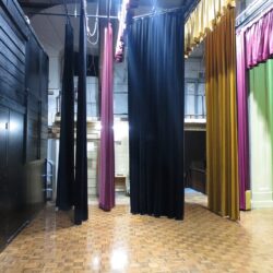 Stage at the Albert Hall in Canberra (20160 taken from stage right looking stage left. Stage curtains show pink black beige coloured curtains (credit: Johnscotaus, license: CC BY-SA)