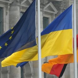 The flags of the EU, Ukraine, and Germany flying at Den Hague (Getty Images)